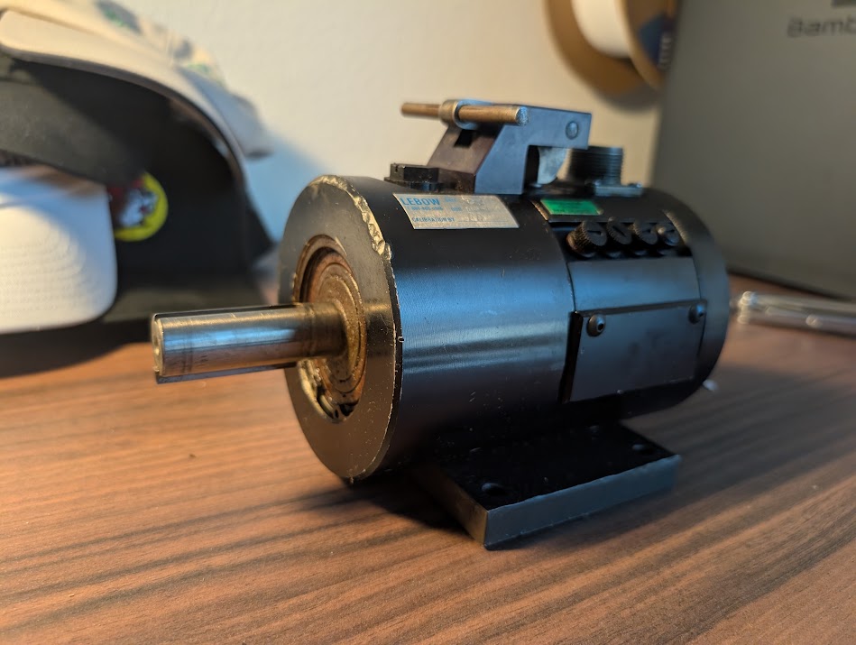 An inline rotary torque transducer on its mounting base.