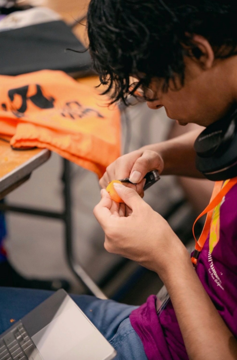 A teammate working on the orange prototype component during the hackathon.